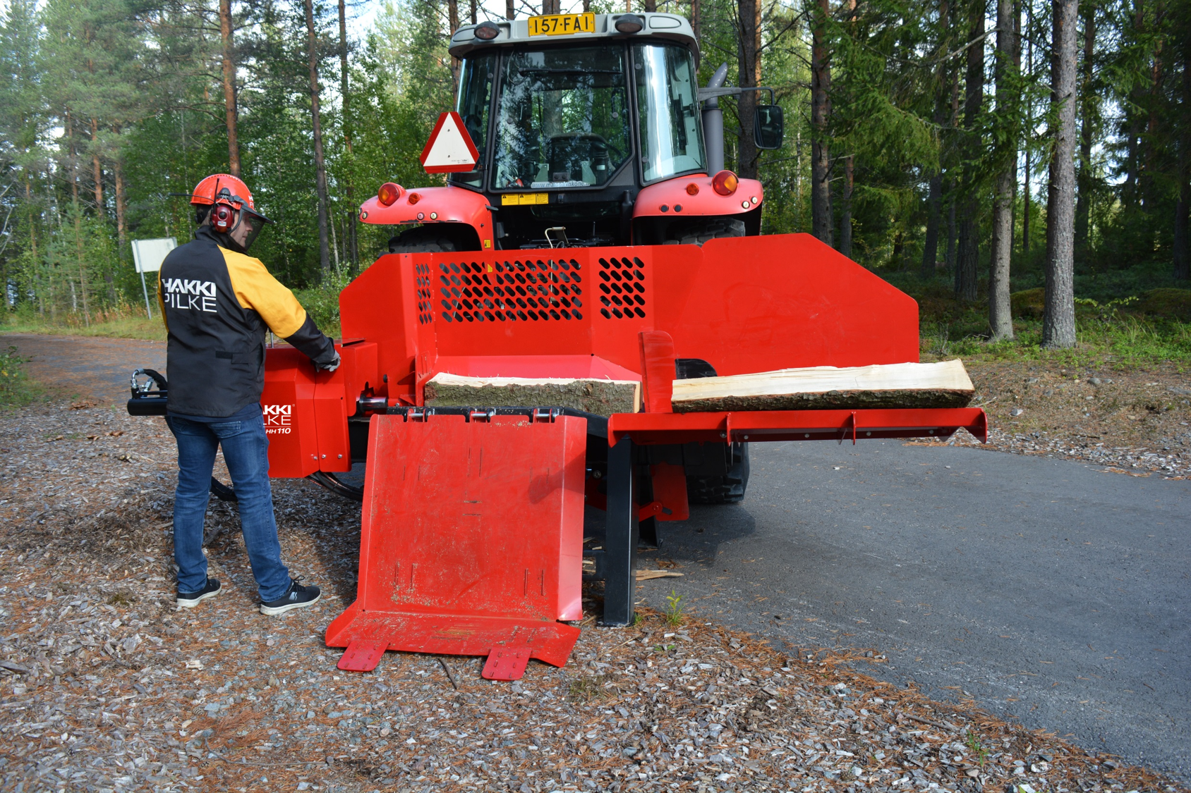 HH110Hakki Pilke HH 110 log splitter in use in the forest.