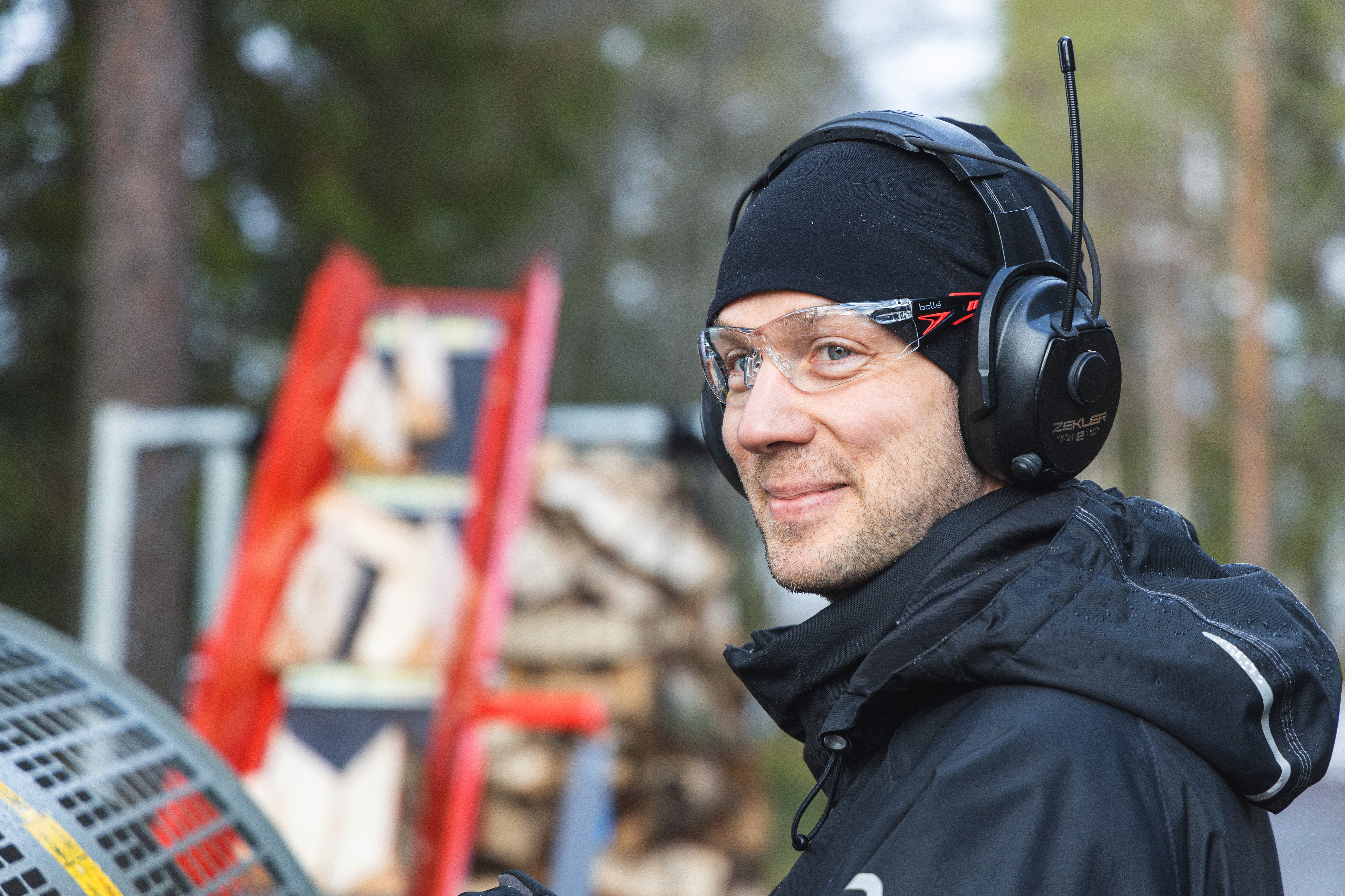 A picture of a smiling man wearing PPE