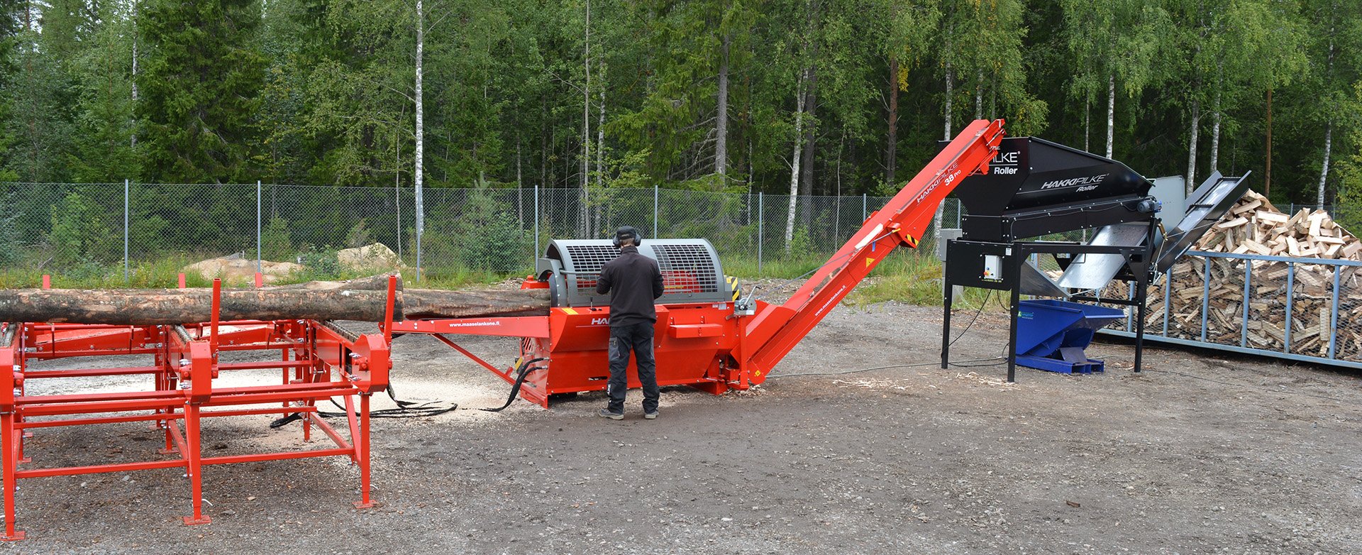 Firewood production on a professional setup with a log table and cleaner.