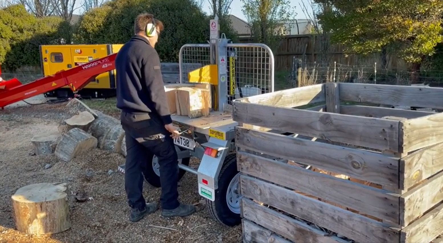 Log splitter in use alongside the firewood processor.