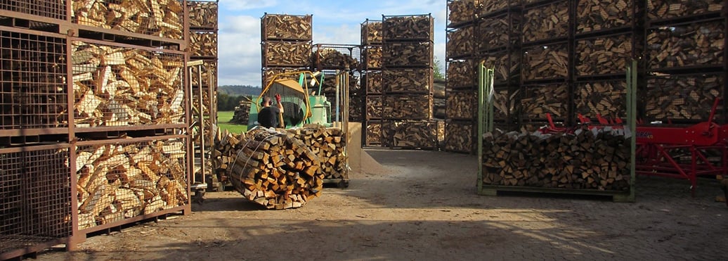 Firewood drying in log cages. 